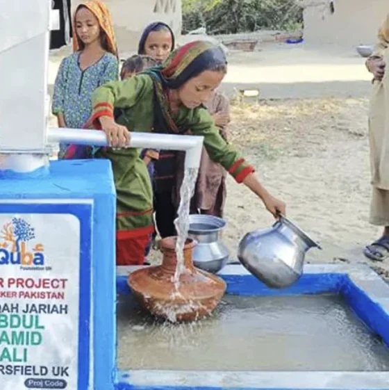 A girl fills a water pot at a Quba water point